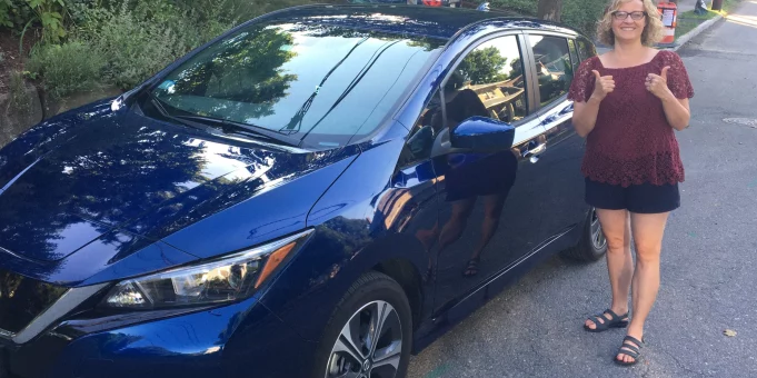 Newton resident with her Nissan Leaf Electric Vehicle